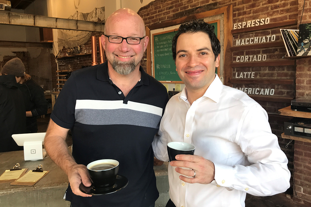 Community member poses for a photo with Signature Symphony's Director, Andrés Franco.