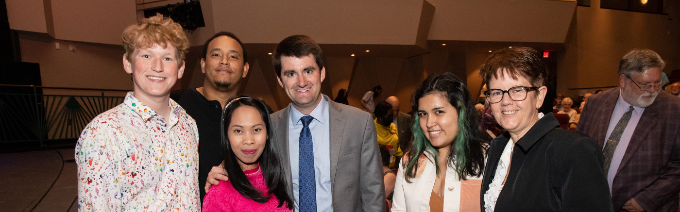 A group of 6 audience members of the 2022 Rachmaninoff show pose for a group photo.